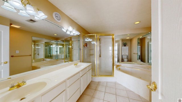 full bathroom featuring toilet, shower with separate bathtub, vanity, and tile patterned floors