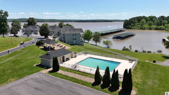 view of swimming pool featuring a water view