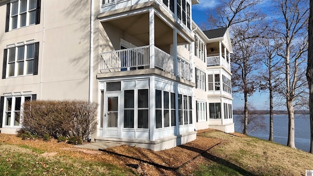 view of side of home with a water view