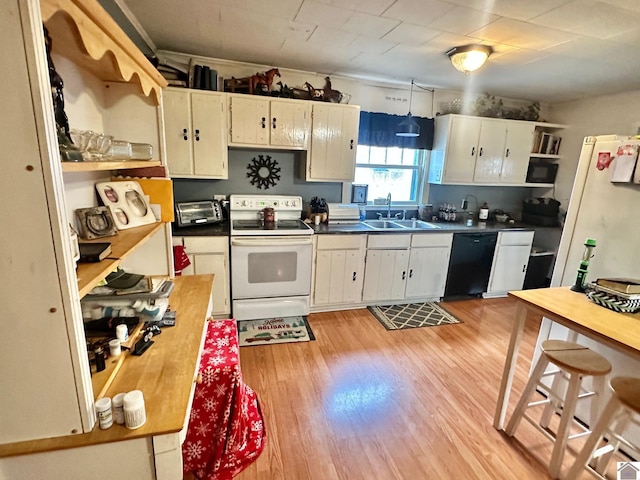 kitchen featuring sink, white cabinets, light hardwood / wood-style floors, and white appliances