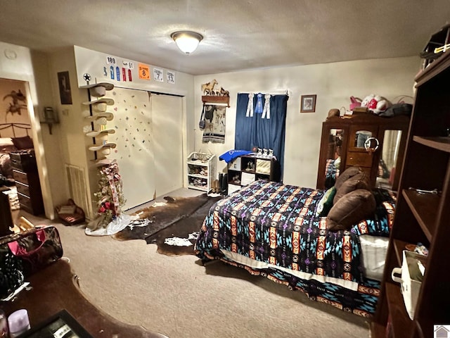 bedroom with a closet, carpet floors, and a textured ceiling