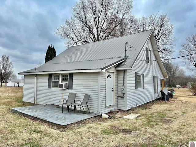 rear view of house with cooling unit, a patio area, and a lawn