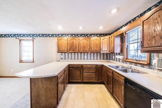 kitchen with sink, a textured ceiling, black dishwasher, plenty of natural light, and kitchen peninsula