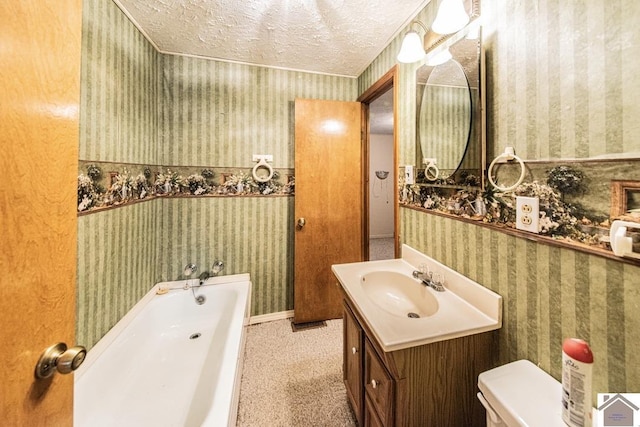 bathroom with vanity, a bath, a textured ceiling, and toilet