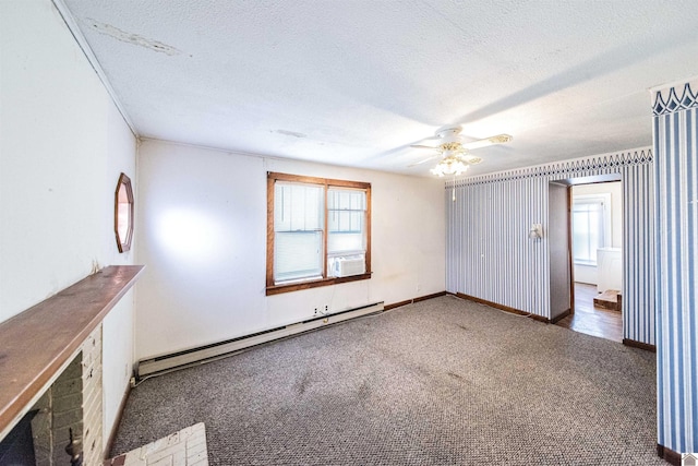 empty room with a textured ceiling, dark carpet, and a baseboard heating unit