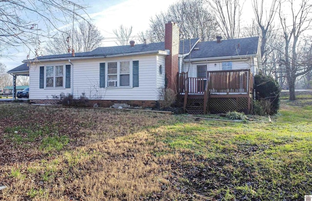 rear view of property with a yard and a deck