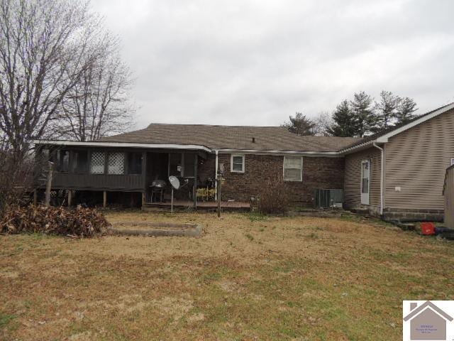 rear view of property featuring a yard