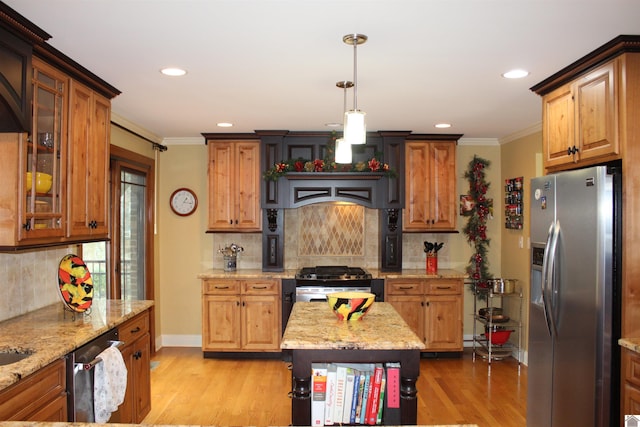 kitchen with stainless steel appliances, light stone counters, tasteful backsplash, and light hardwood / wood-style floors