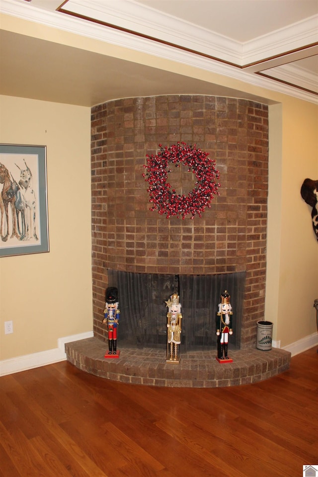 room details with hardwood / wood-style floors, crown molding, and a brick fireplace