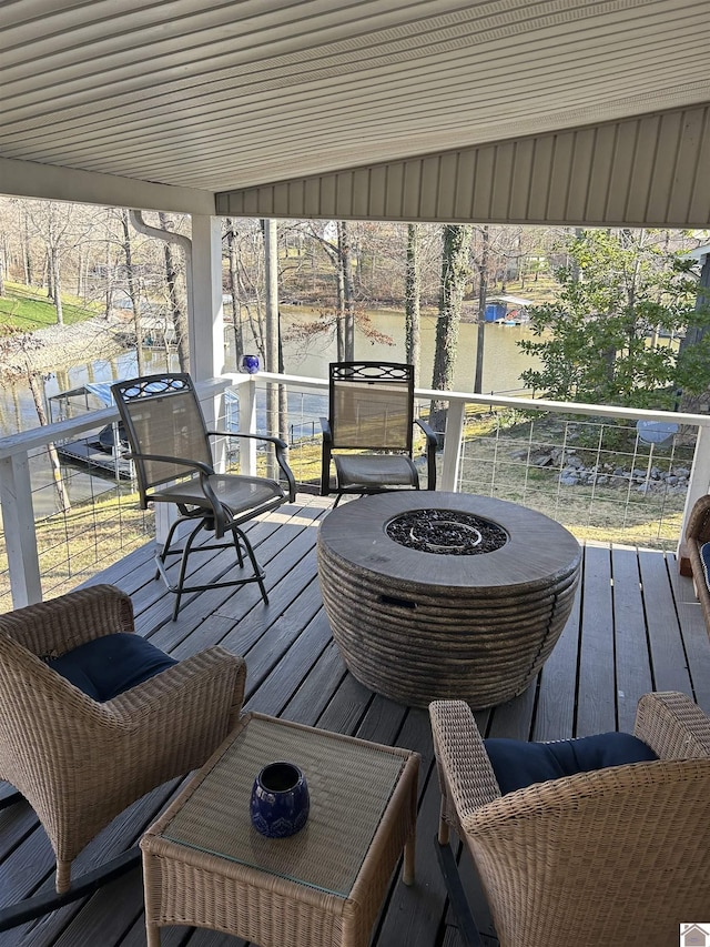 wooden terrace featuring a fire pit