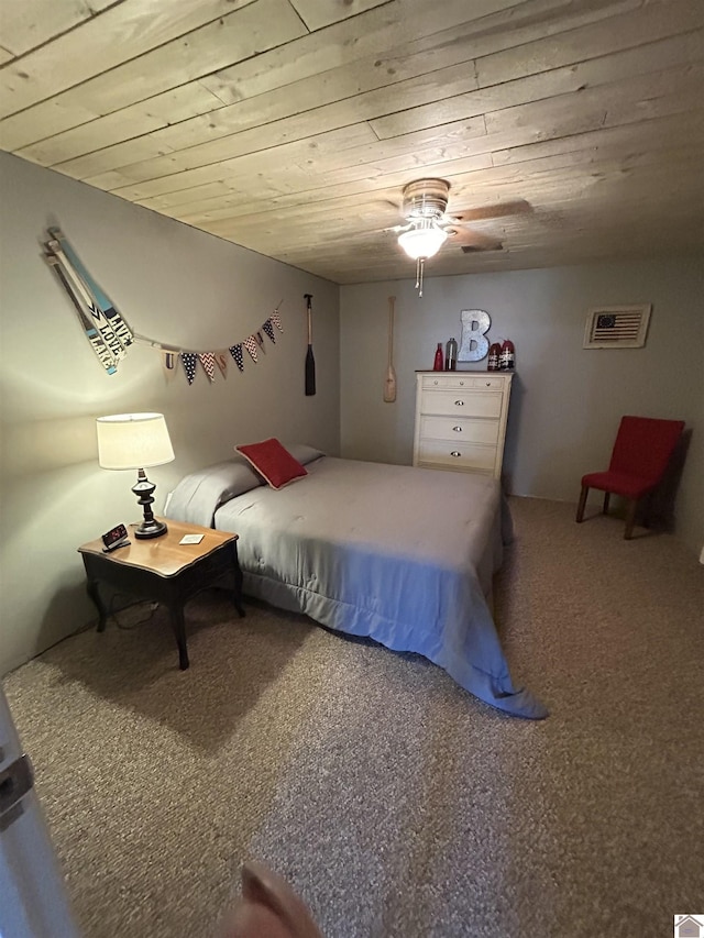 carpeted bedroom with ceiling fan and wooden ceiling