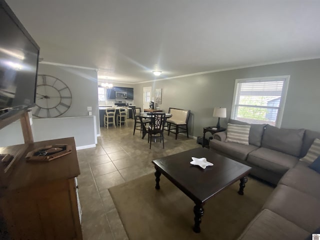 living room featuring tile patterned floors, a healthy amount of sunlight, and ornamental molding