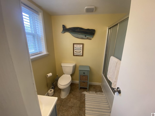 full bathroom featuring tile patterned floors, toilet, combined bath / shower with glass door, and vanity