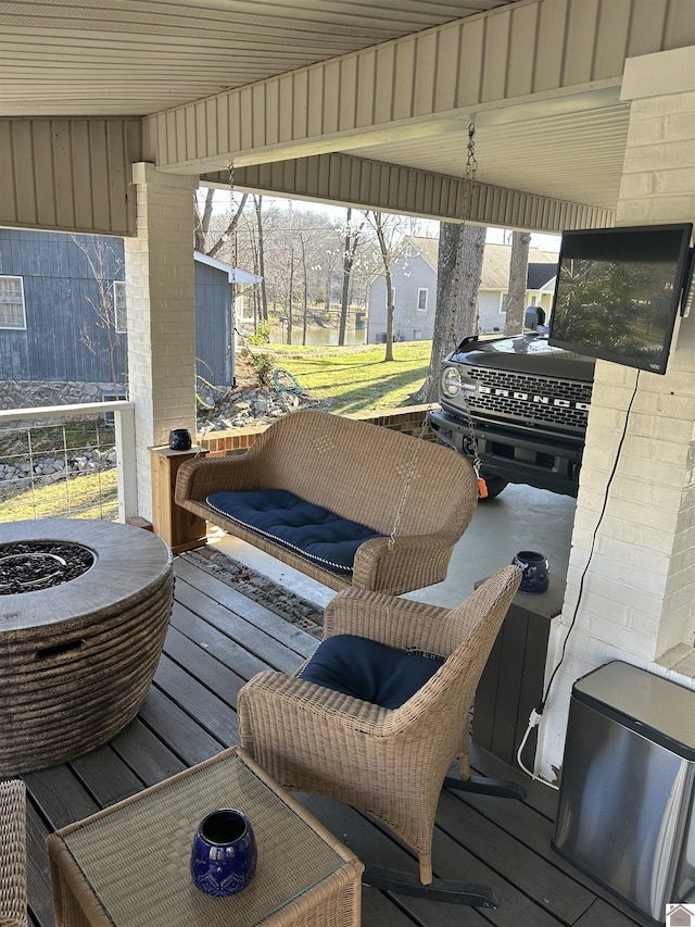 view of patio with a wooden deck and an outdoor fire pit