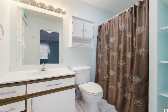 bathroom featuring tile patterned floors, vanity, curtained shower, and toilet