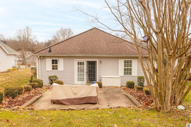 rear view of property with a patio area and a yard