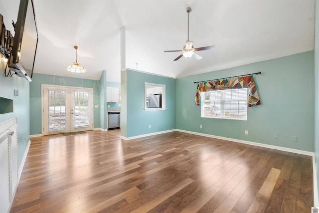 unfurnished living room featuring hardwood / wood-style floors, ceiling fan, french doors, and vaulted ceiling