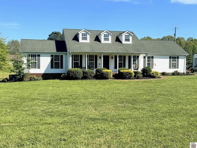 cape cod-style house featuring a front yard