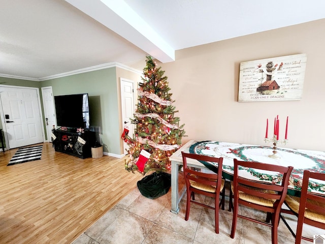 dining room with crown molding and tile patterned flooring