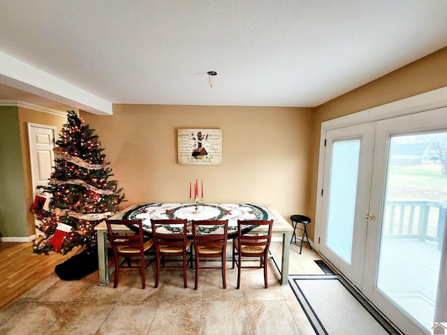 tiled dining area featuring french doors