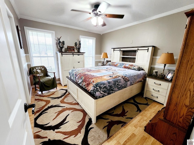 bedroom featuring light wood-type flooring, ceiling fan, and ornamental molding