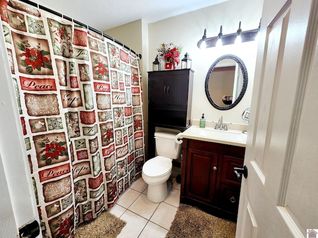 bathroom with tile patterned floors, vanity, and toilet