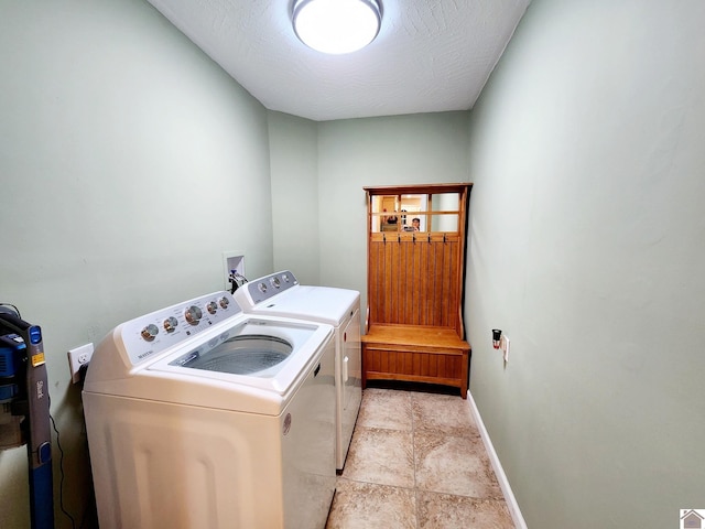 clothes washing area with separate washer and dryer