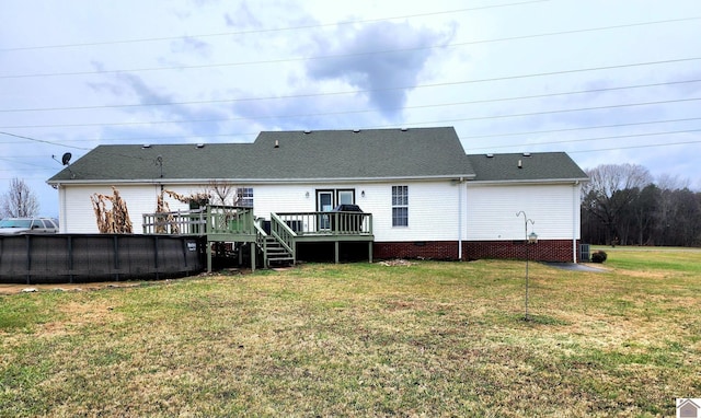 back of house featuring a lawn and a pool side deck