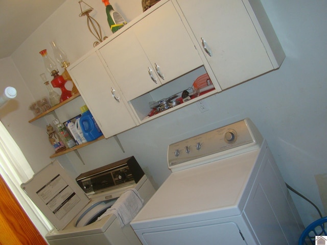 washroom featuring cabinets and washer and dryer