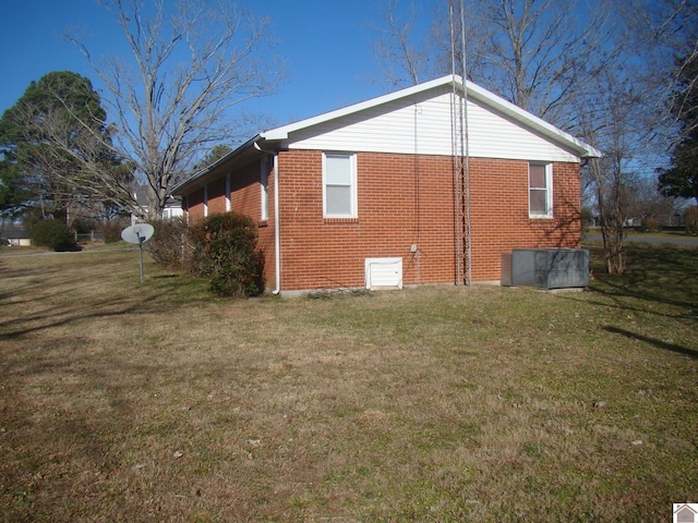 view of side of home featuring a lawn