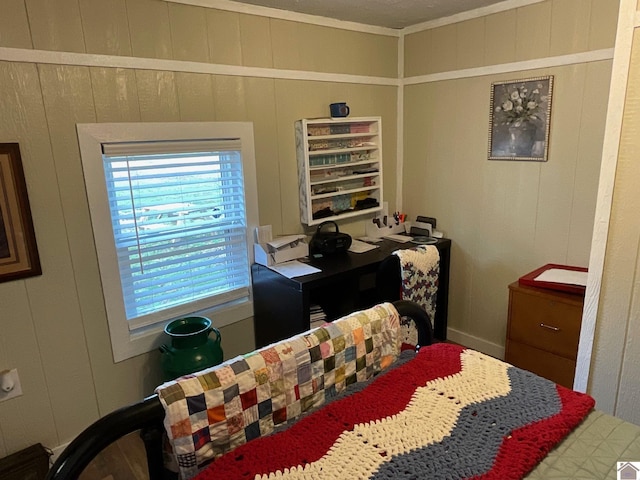 bedroom featuring wood walls