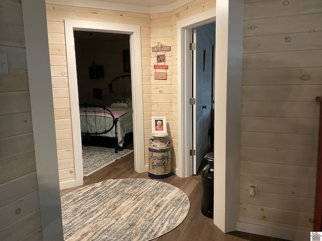 hallway with wood walls and dark hardwood / wood-style flooring