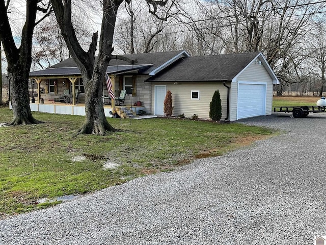 view of front facade with a porch, a garage, and a front lawn