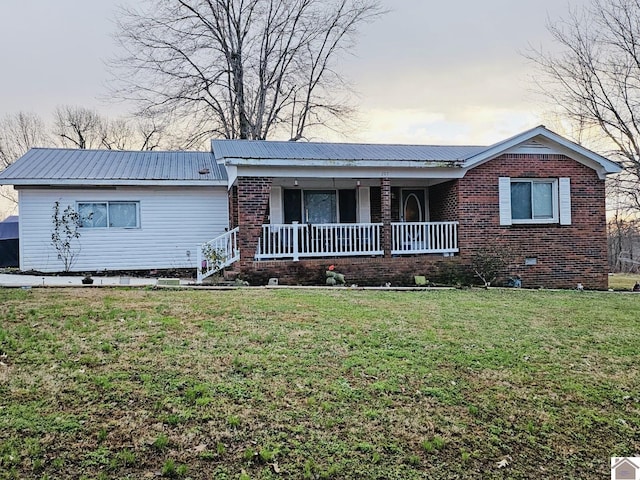 ranch-style home with a porch and a yard