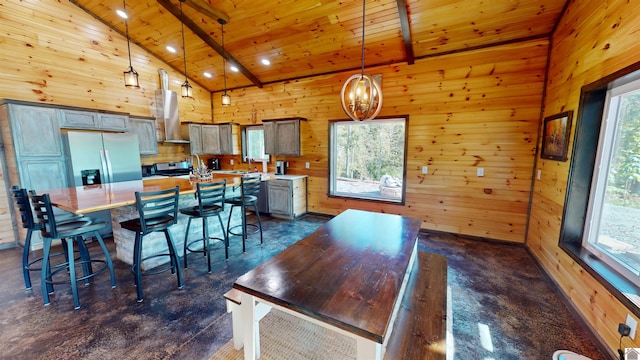 kitchen featuring pendant lighting, a kitchen island, wooden ceiling, and beam ceiling