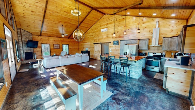 living room featuring wood walls, high vaulted ceiling, a barn door, beam ceiling, and wood ceiling