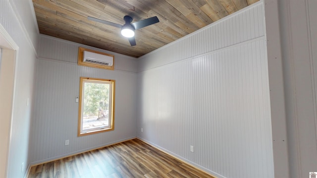 unfurnished room featuring a wall mounted air conditioner, wood-type flooring, ceiling fan, and wood ceiling