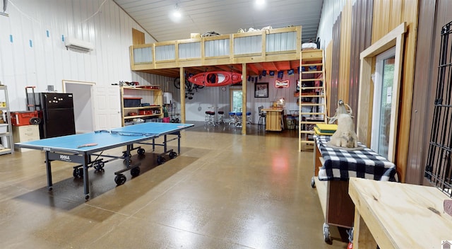 game room with wood walls