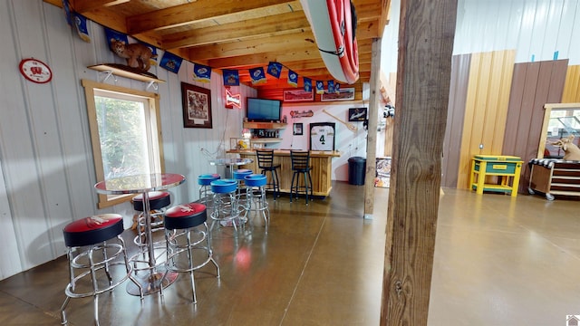 interior space with bar area and wooden walls