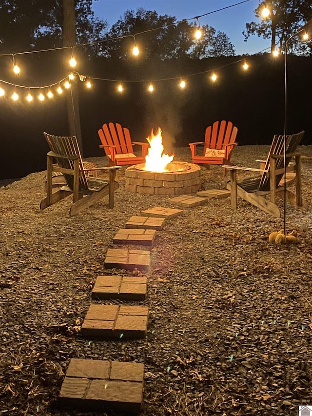 view of yard featuring an outdoor fire pit