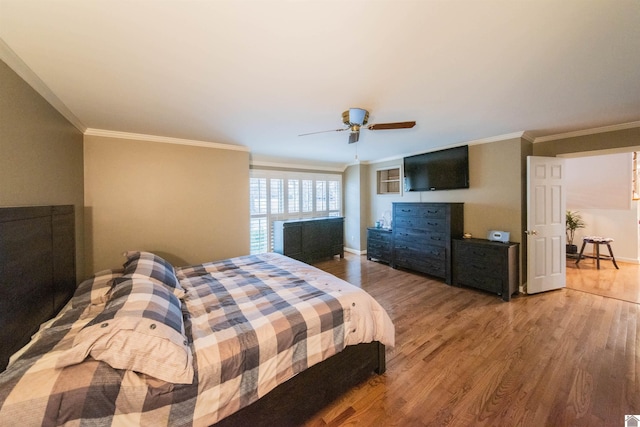 bedroom with hardwood / wood-style floors, ceiling fan, and crown molding