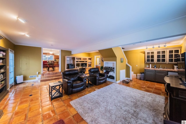 living room with tile patterned floors, radiator, and crown molding