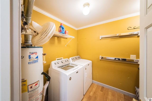 laundry area featuring gas water heater, washing machine and clothes dryer, ornamental molding, and light hardwood / wood-style flooring