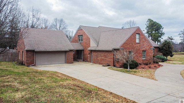 view of front of property with a front yard and a garage