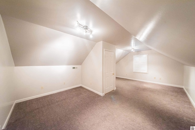 bonus room with carpet flooring and lofted ceiling