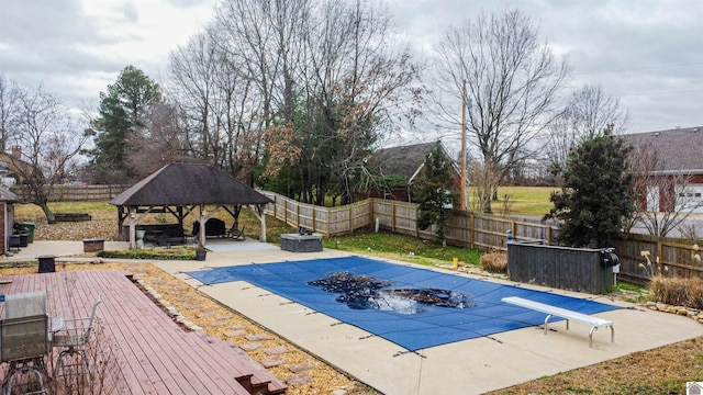 view of pool with a gazebo, a patio, a diving board, and a wooden deck