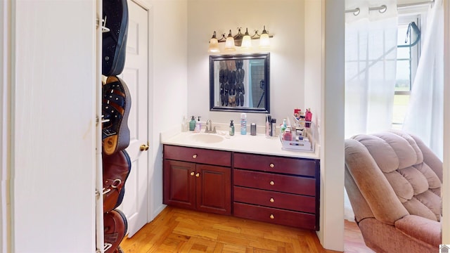 bathroom featuring parquet flooring and vanity