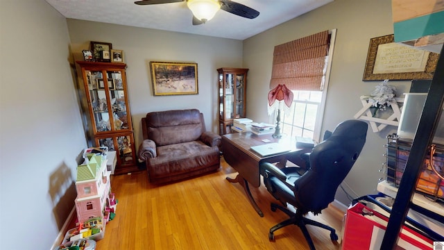 home office featuring ceiling fan and hardwood / wood-style flooring