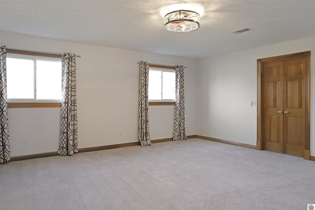 unfurnished room featuring light colored carpet