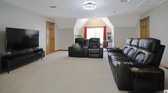 carpeted living room with a textured ceiling and lofted ceiling